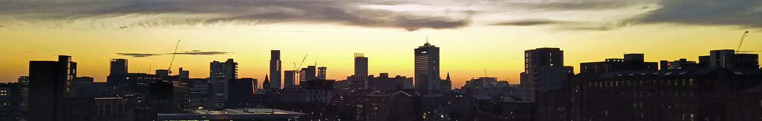 A cityscape of Manchester at night.